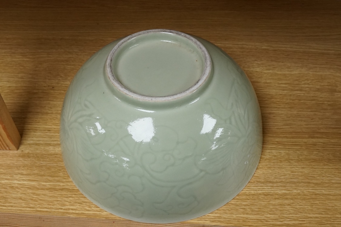 A Chinese celadon glazed ‘Phoenix’ wine ewer, late 19th century/ early 20th century, and a celadon glazed bowl, largest 26cm high